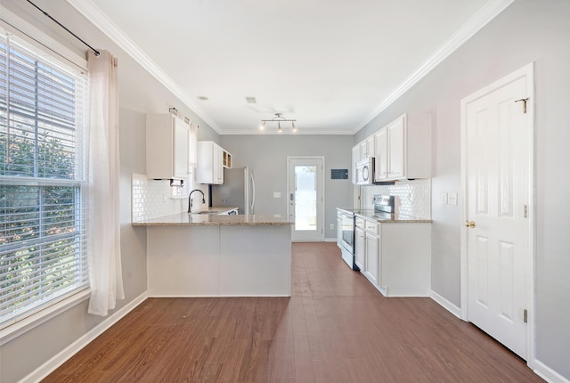 kitchen with stainless steel appliances, tasteful backsplash, light stone counters, kitchen peninsula, and white cabinets