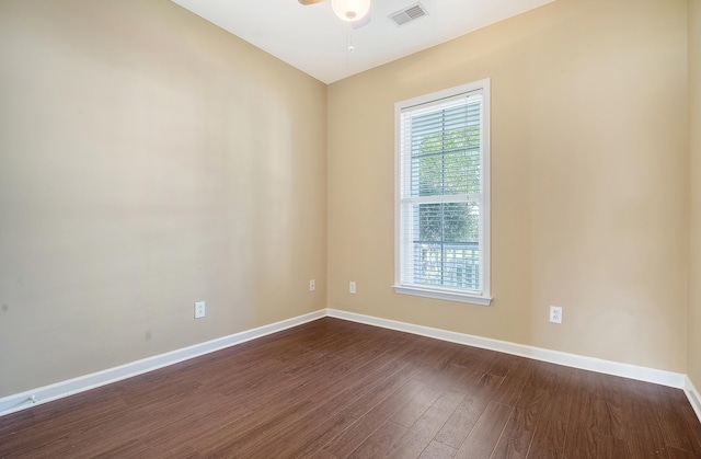 unfurnished room featuring ceiling fan and dark wood-type flooring