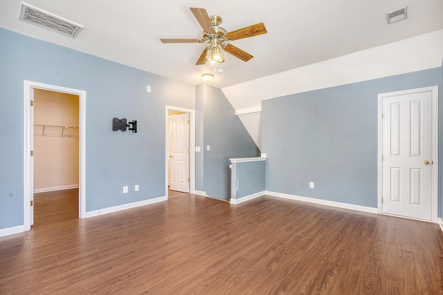 interior space with lofted ceiling, ceiling fan, and dark wood-type flooring