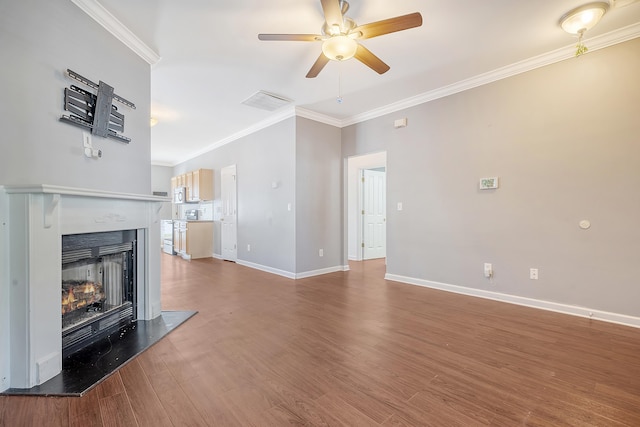 unfurnished living room with ceiling fan, wood-type flooring, and ornamental molding