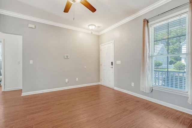 empty room featuring hardwood / wood-style floors, ceiling fan, and ornamental molding