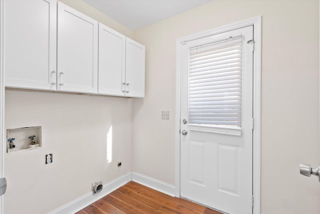 laundry room with wood finished floors, cabinet space, baseboards, hookup for an electric dryer, and hookup for a washing machine