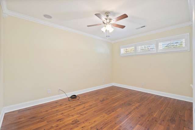 unfurnished room with baseboards, dark wood-style floors, and ornamental molding