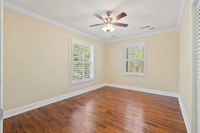 unfurnished room with dark wood finished floors, visible vents, ceiling fan, and ornamental molding