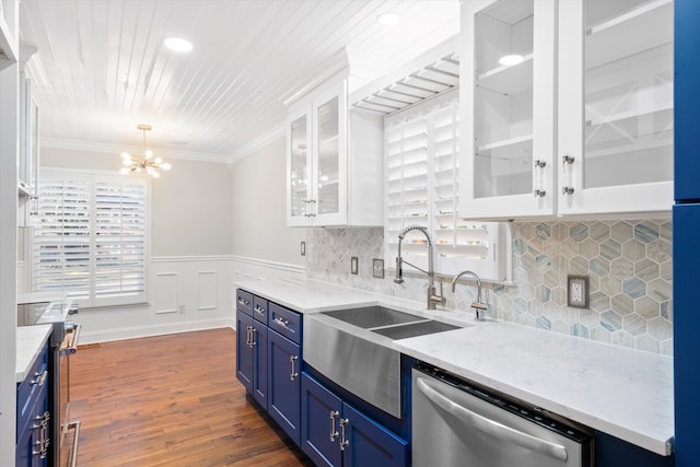 kitchen featuring blue cabinets, a wealth of natural light, a sink, white cabinetry, and stainless steel appliances