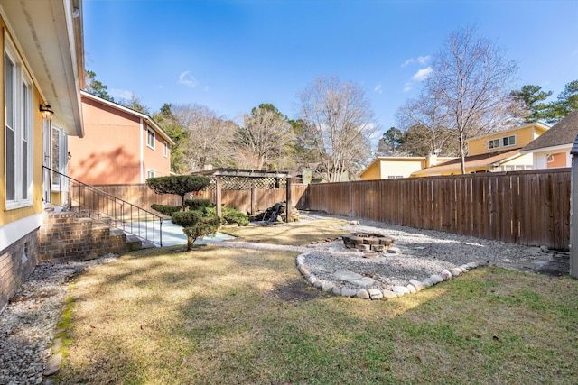 view of yard featuring a patio area, a fire pit, a pergola, and a fenced backyard