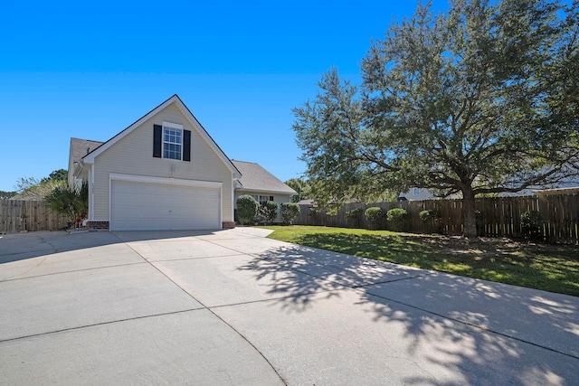 view of front of home with a front yard and a garage