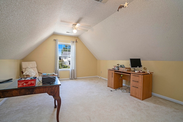 carpeted home office featuring ceiling fan, a textured ceiling, and vaulted ceiling