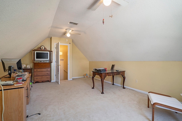 office featuring ceiling fan, a textured ceiling, lofted ceiling, and light colored carpet