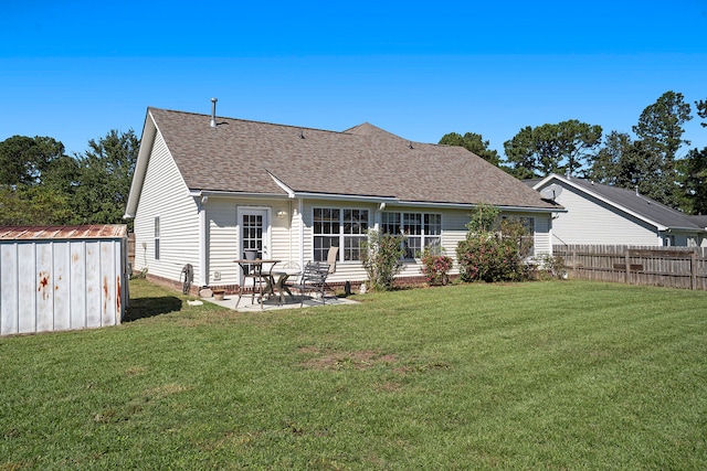 back of house featuring a patio, a shed, and a yard