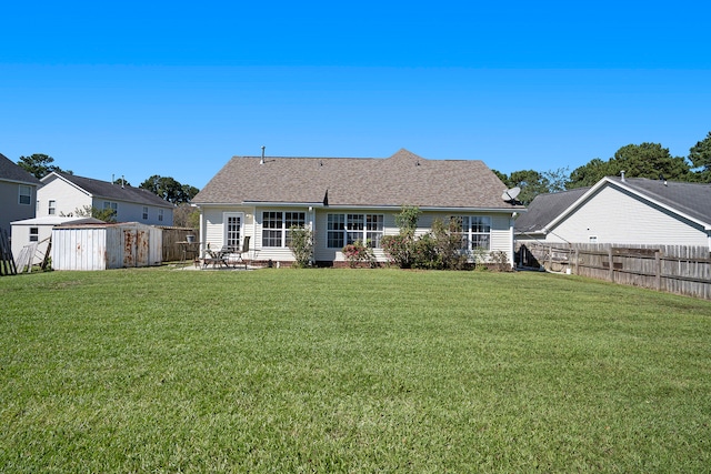 back of house featuring a shed and a yard