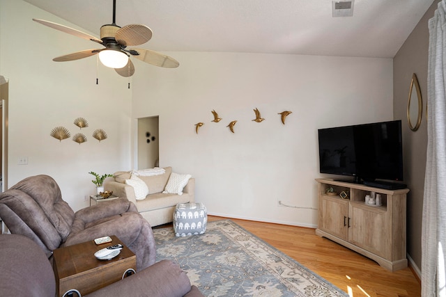 living room with light hardwood / wood-style flooring, lofted ceiling, and ceiling fan