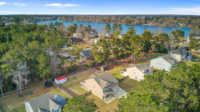 birds eye view of property featuring a view of trees, a water view, and a residential view