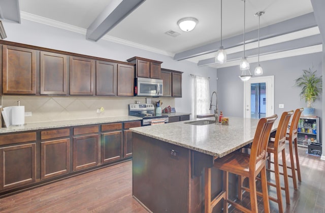 kitchen featuring a sink, stainless steel appliances, beam ceiling, and dark wood-style floors