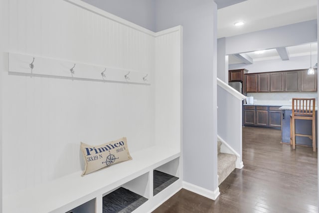 mudroom featuring beamed ceiling, baseboards, and dark wood-style floors