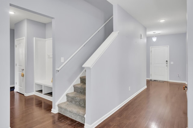 stairs featuring baseboards and wood finished floors