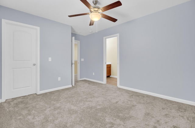 unfurnished bedroom with carpet, baseboards, ensuite bathroom, and ceiling fan