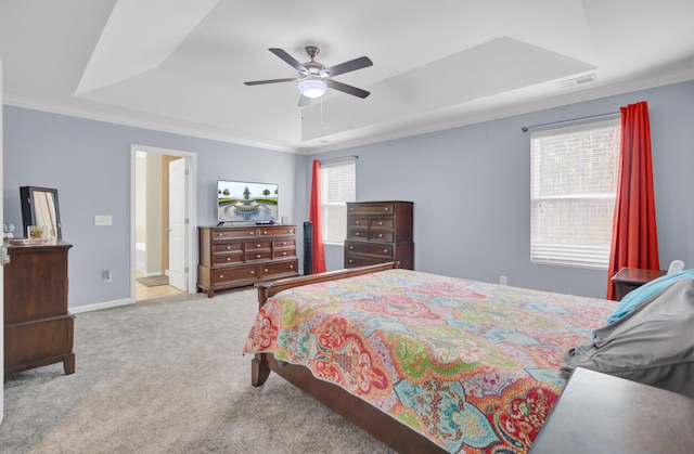 bedroom with visible vents, a tray ceiling, carpet floors, crown molding, and baseboards