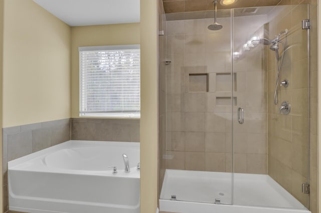 bathroom featuring a garden tub and a stall shower