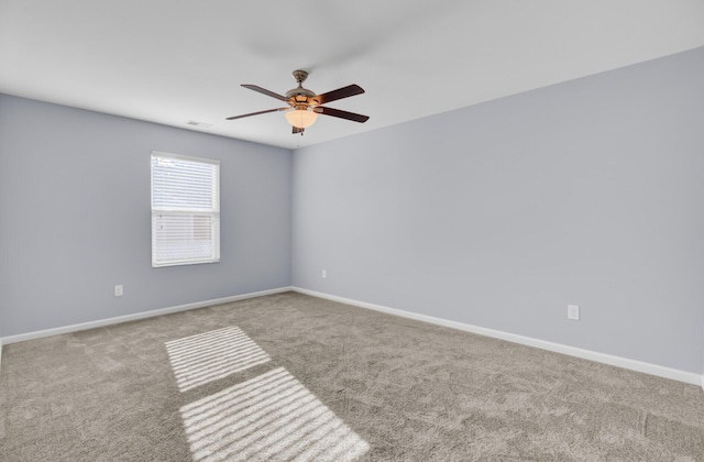 unfurnished room featuring baseboards, visible vents, a ceiling fan, and carpet