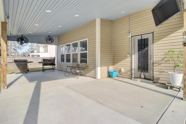 view of patio featuring area for grilling and fence