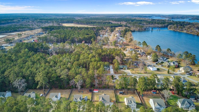 aerial view featuring a forest view and a water view