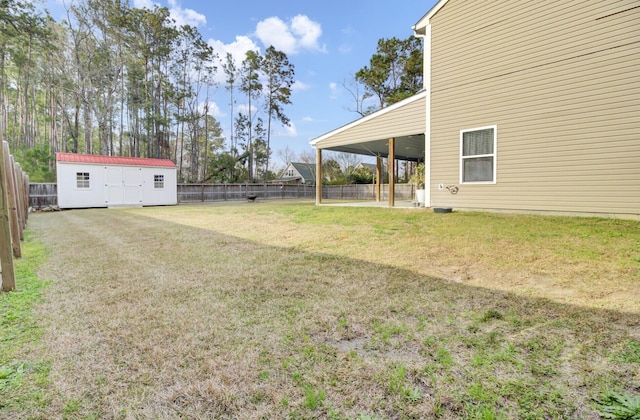 view of yard with an outbuilding, a storage unit, and a fenced backyard