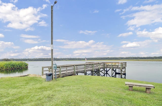 view of dock featuring a yard and a water view