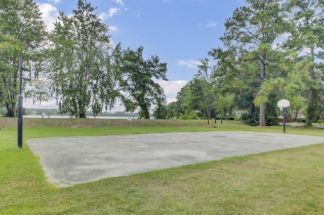 view of basketball court with community basketball court and a yard