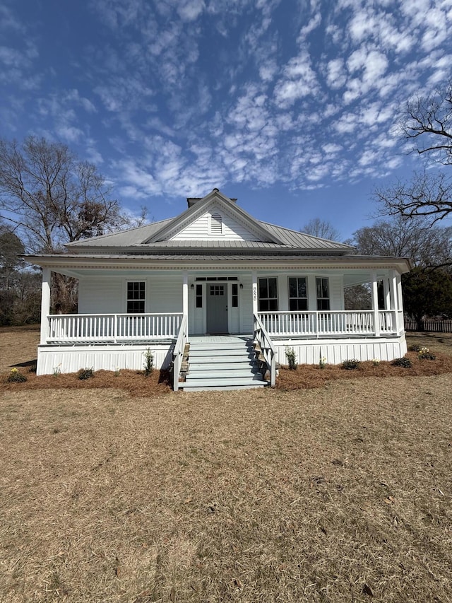 view of front facade featuring covered porch and metal roof