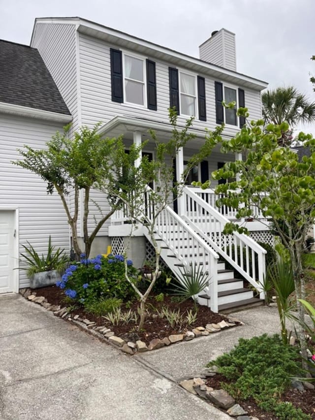 324 Wild Horse Ln, Mount Pleasant, SC 29464 - view of front facade with a chimney, driveway, a porch, a garage, and stairway