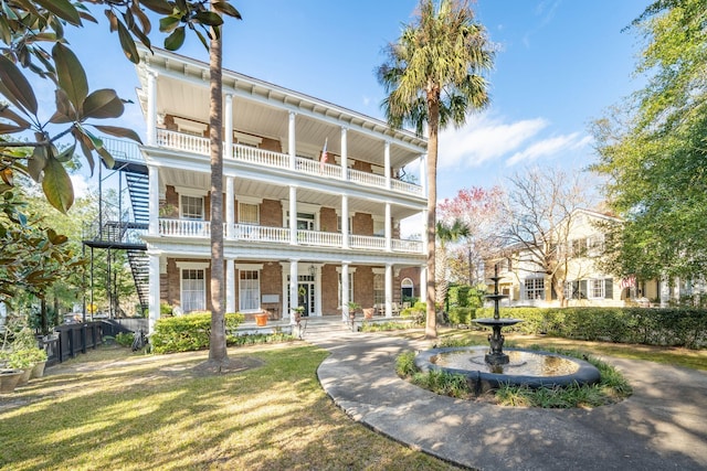 view of front facade with a balcony and covered porch