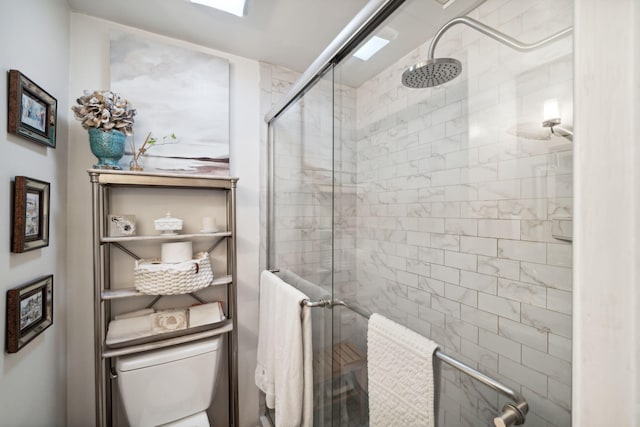 bathroom with toilet and an enclosed shower