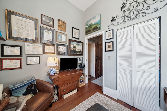 sitting room featuring a barn door and dark hardwood / wood-style floors