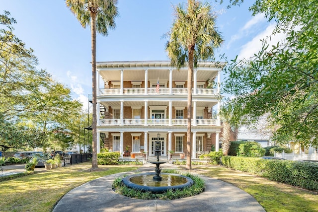 view of front facade featuring a balcony and covered porch