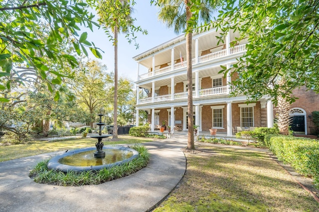 view of front of house with a balcony and covered porch