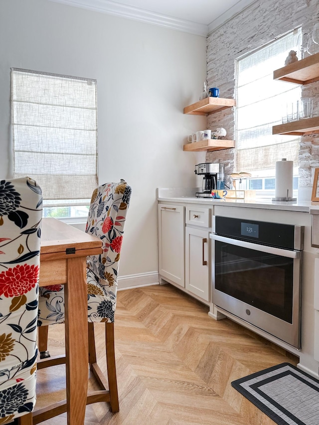 10 Riker St, Charleston, SC 29403 - kitchen with oven, open shelves, ornamental molding, and plenty of natural light