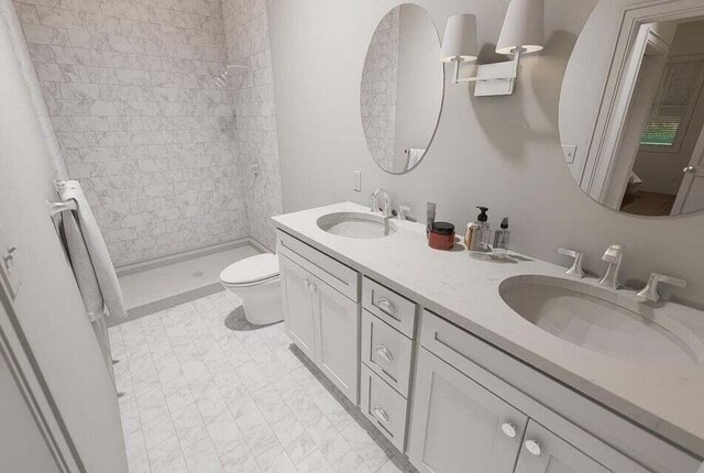 bathroom featuring vanity, toilet, and a tile shower