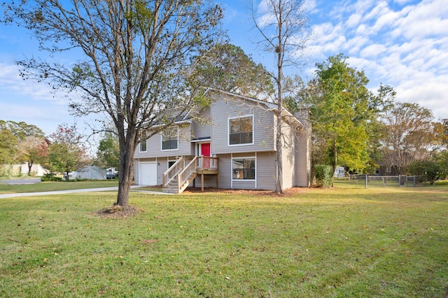 bi-level home featuring a garage and a front yard