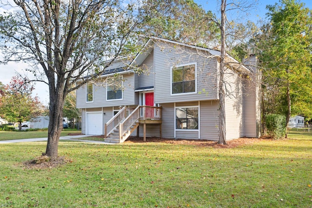 split foyer home featuring a garage and a front lawn