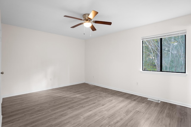 empty room with hardwood / wood-style flooring and ceiling fan