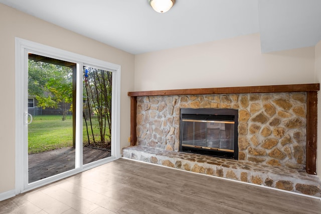 unfurnished living room featuring hardwood / wood-style flooring and a fireplace