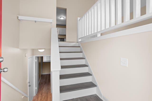 staircase featuring hardwood / wood-style flooring