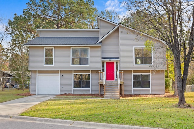 raised ranch with a garage and a front lawn