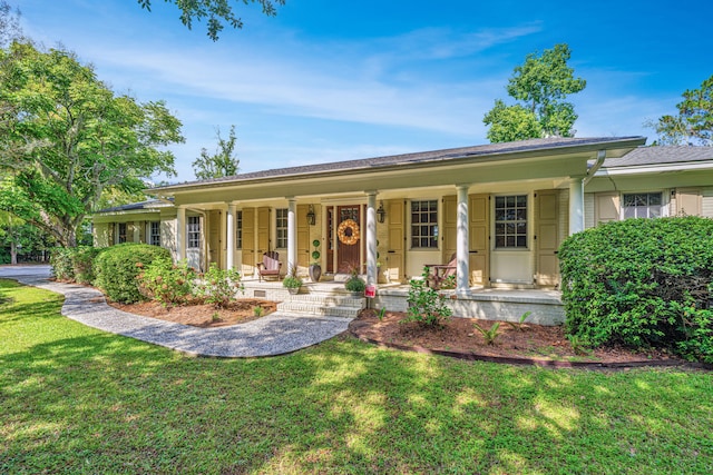 ranch-style home with a porch and a front lawn