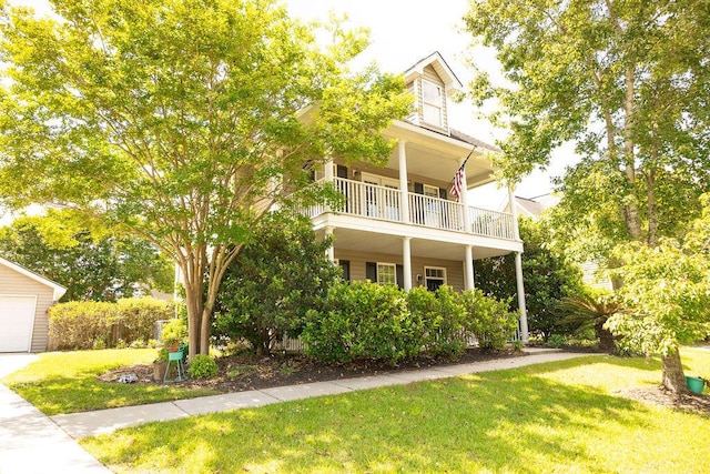 view of front of house featuring a balcony and a front yard