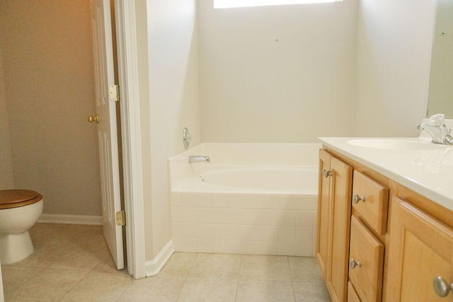 bathroom with vanity, tile patterned flooring, toilet, and a bath