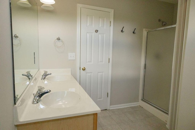 full bath with double vanity, a sink, tile patterned flooring, and a shower stall