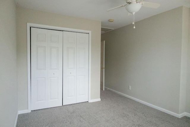unfurnished bedroom featuring carpet floors, baseboards, a closet, and ceiling fan