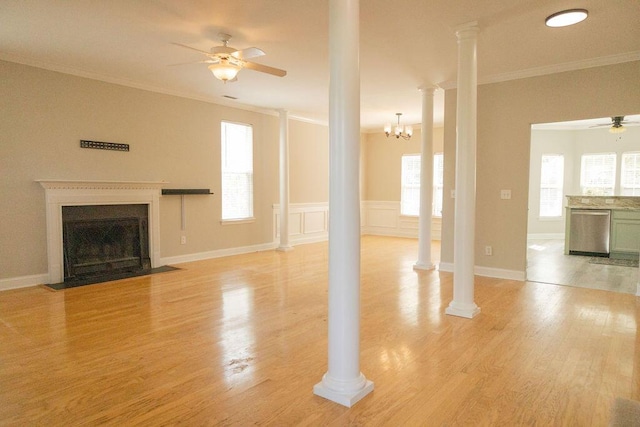 unfurnished living room with crown molding, a ceiling fan, light wood finished floors, and a fireplace with flush hearth